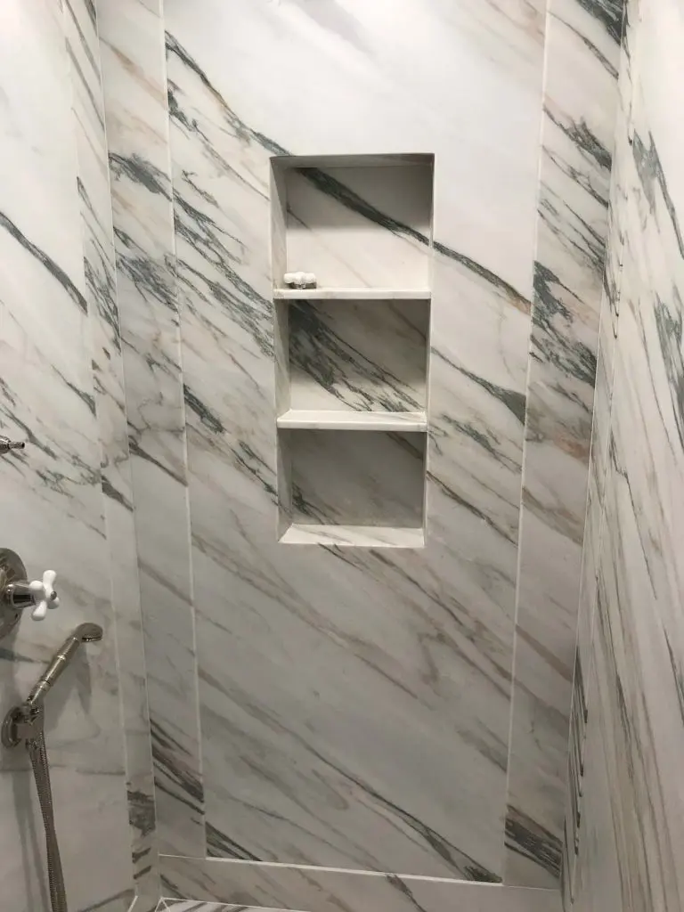 Shower with white and grey marble tile
